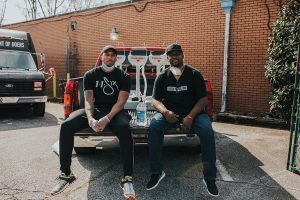 Lecrae and Terence deliver portable hand washing station.